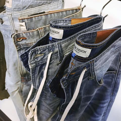 Hyper Denim jeans are hanging from a rack, showing off their street style jean style and high quality fabric.